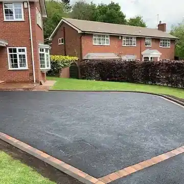 Tarmac drive with a brick edge